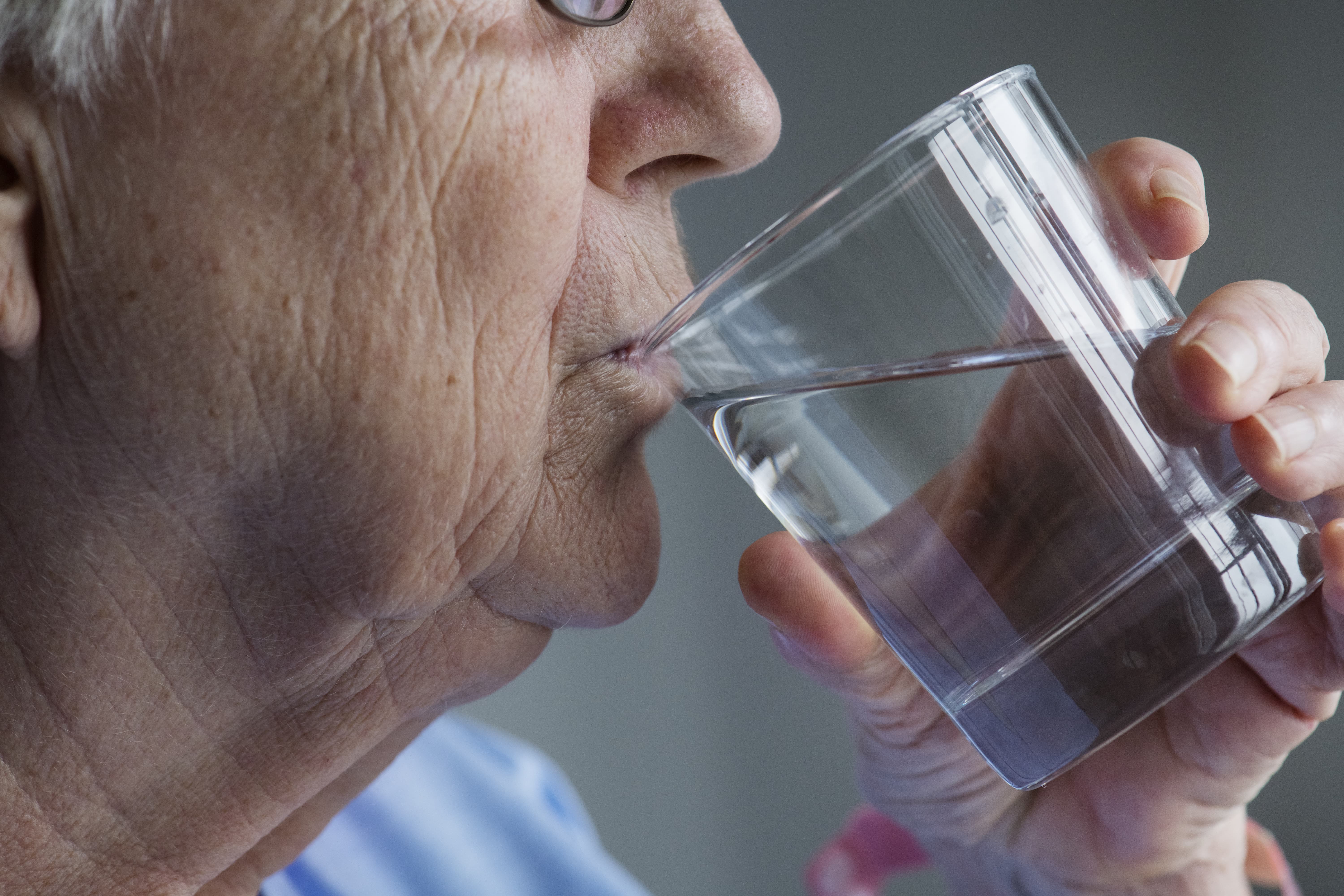 side view of elderly woman drinking water 1